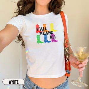 May include: White cropped t-shirt with a rainbow boot graphic and the text "Y'all Means All".
