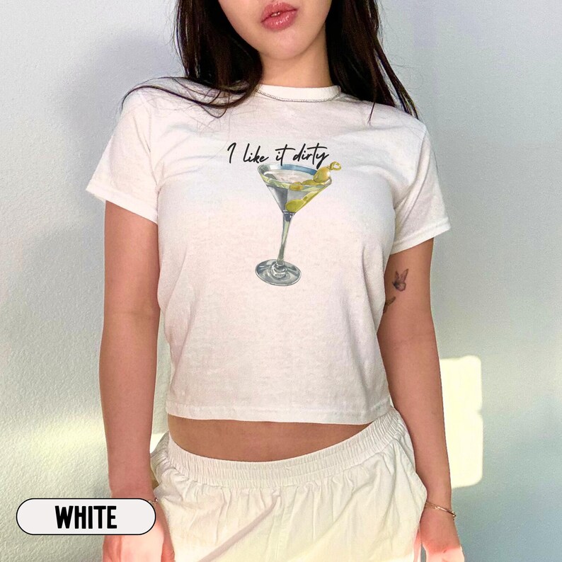 May include: White cropped t-shirt with the text "I like it dirty" and a martini glass graphic.