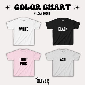 May include: Color chart for Gildan 5000B t-shirts. The chart shows four t-shirts in different colors: white, black, light pink, and ash.