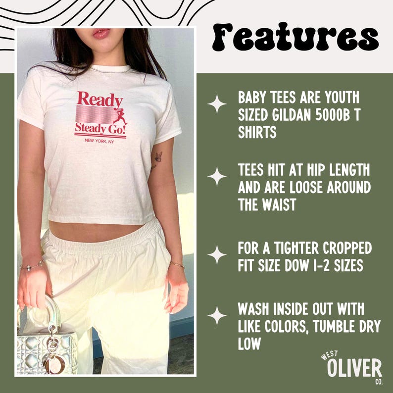 May include: A white short-sleeved t-shirt with red text that reads Ready Steady Go! NEW YORK, NY and a graphic of a runner. The text on the right side lists product features including youth sizing, fit details, and care instructions for the garment.
