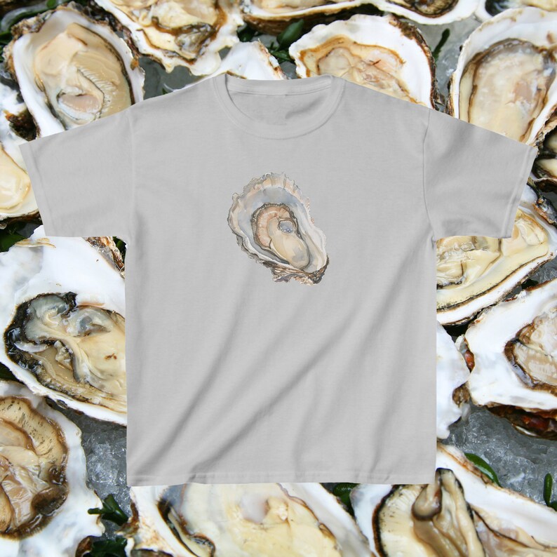 May include: A light grey t-shirt with a watercolour illustration of an oyster shell on the front.