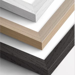 The three types of frames that we offer: white, wood, and black. The frames are available in two materials: ash and oak wood.