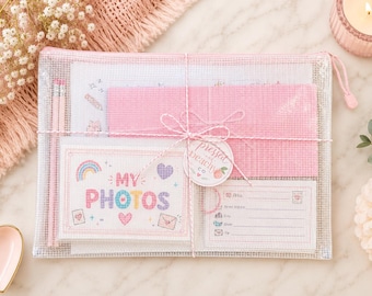 May include: A clear mesh zipper pouch containing a pink fabric sheet, two pencils, and two cards. One card features the text MY PHOTOS with a rainbow and hearts. The other card is a mailing label with the text FROM, Street Address, City, State, and Zip.