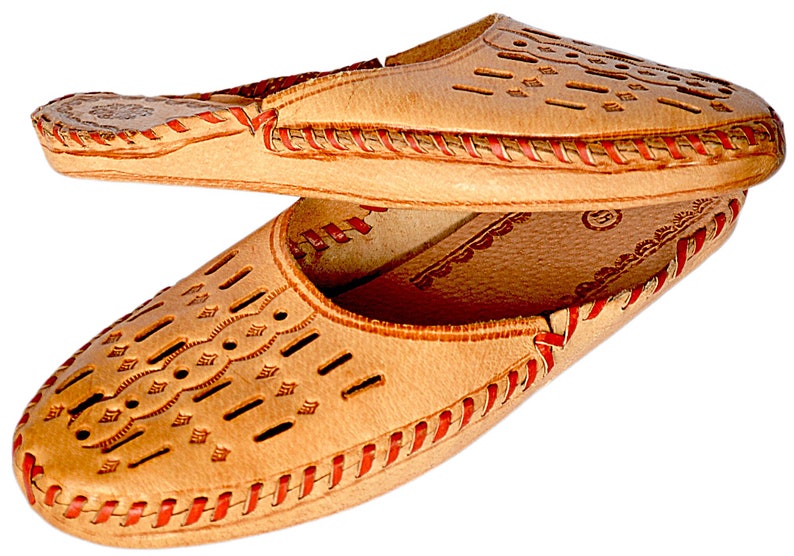 May include: A pair of tan leather slippers with red stitching and a decorative cut-out pattern. The slippers have a pointed toe and a flat sole.