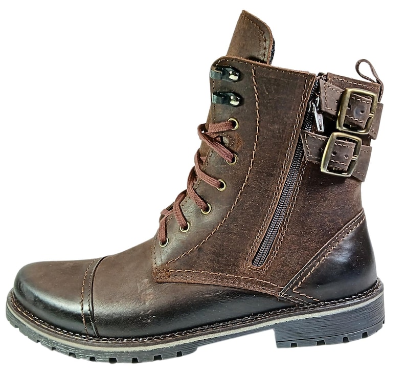 Detail of laced front and side zipper on casual chukka-style combat boots, combining fashion with function