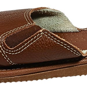 Close-up of soft sheepskin-cushioned footbed showing plush texture and comfort detail inside the leather sandals