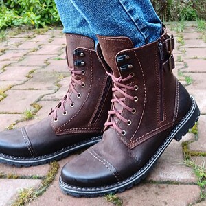 Profile view of men’s motorcycle-style leather boots with a functional side zipper, ankle height design, and durable stitching details.