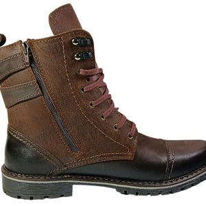 Detail of laced front and side zipper on casual chukka-style combat boots, combining fashion with function.