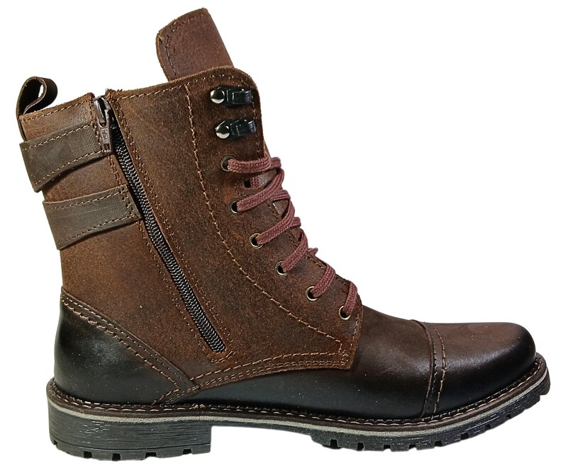 Detail of laced front and side zipper on casual chukka-style combat boots, combining fashion with function.