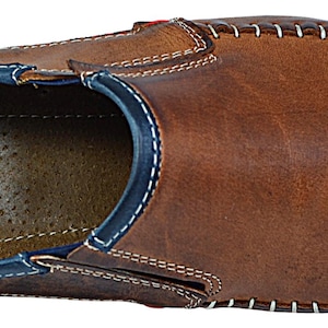 Top-down image of men's leather loafers, highlighting a soft sheepskin inner lining for breathability.