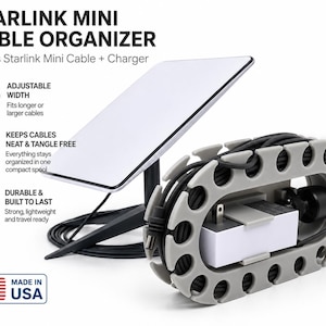 May include: A grey plastic Starlink Mini cable organiser spool holding a white power adapter and black cable, positioned next to a Starlink Mini satellite dish on a stand. Text includes STARLINK MINI CABLE ORGANISER and MADE IN USA.