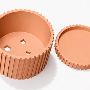 May include: A set of three ceramic mugs with a speckled, matte finish. The mugs are in shades of cream, light gray, and dark gray. Each mug has a simple, minimalist design and a rounded handle.