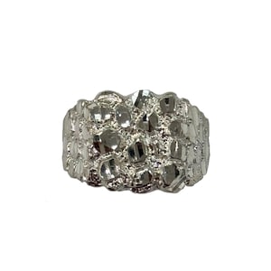 May include: A silver ring with a textured, nugget-like design.