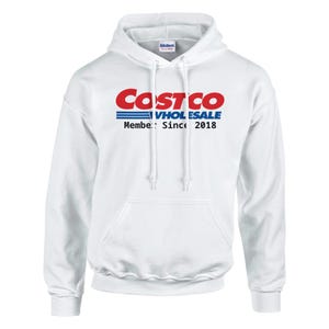 May include: White hooded sweatshirt with the Costco Wholesale logo in red and blue. The text "Member: Since 2018" is printed below the logo. The sweatshirt has a front pocket and drawstring hood.