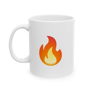 May include: White ceramic mug with a red and orange flame graphic.