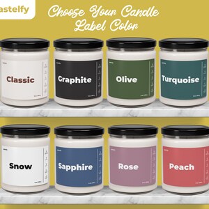 May include: Eight glass candle jars with black lids and white labels. The labels have different colors and the words "Classic", "Graphite", "Olive", "Turquoise", "Snow", "Sapphire", "Rose", and "Peach" printed on them.