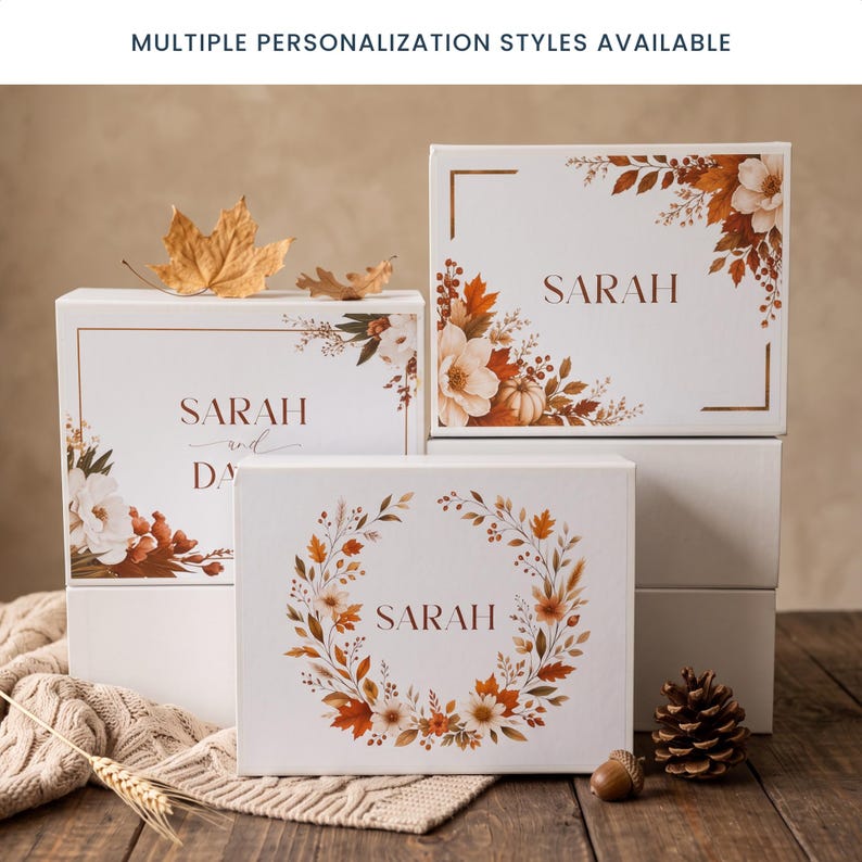 May include: Three white rectangular gift boxes featuring autumn-themed floral and leaf illustrations in shades of orange, brown, and cream. The boxes are personalized with the name SARAH or SARAH AND DAVID. Text at the top reads: MULTIPLE PERSONALIZATION STYLES AVAILABLE.