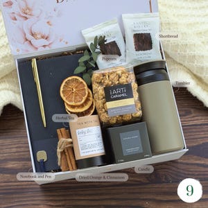 Snack-filled gift basket for men with shortbread, popcorn, herbal tea, insulated tumbler and notebook — employee appreciation gift
