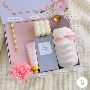 Hygge gift basket for her with notebook, pen, candle, ceramic mug with 
hot cocoa, dried flowers, and chocolate — thoughtful birthday gift