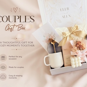 May include: A couples gift box with a white mug, gold spoon, chocolate bar, and small bouquet. The box includes a card and a candle. The box is white with the words "Couples Gift Box" on the front.