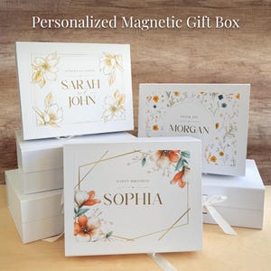 May include: Four white gift boxes with magnetic closures. Each box features a different floral design and personalized text. The top box says "Congratulations Sarah and John". The second box says "Thank you Morgan". The third box says "Happy Birthday Sophia".