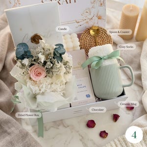 Cozy gift basket with dried flower bouquet, candle, ceramic mug, gourmet 
cookies and spices — thoughtful spa gift for her any occasion