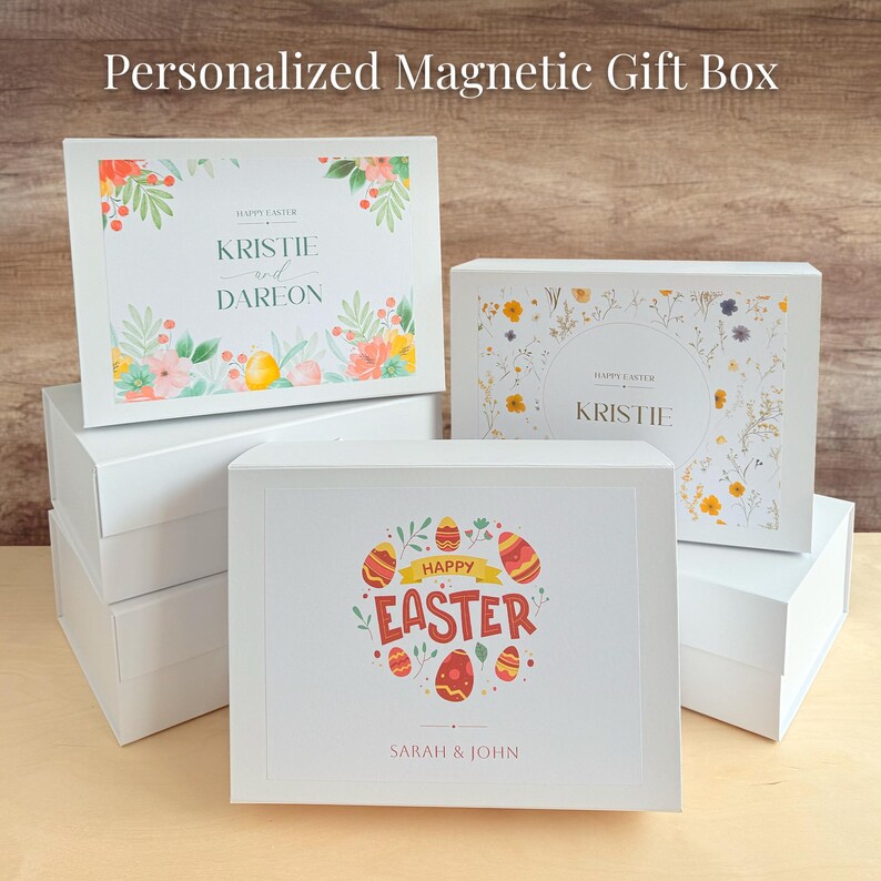 May include: Set of four white gift boxes with magnetic closures. The boxes are decorated with floral patterns and Easter-themed designs. The top box features the text "HAPPY EASTER KRISTIE and DAREON". The second box features the text "HAPPY EASTER KRISTIE". The third box features the text "HAPPY EASTER SARAH & JOHN".