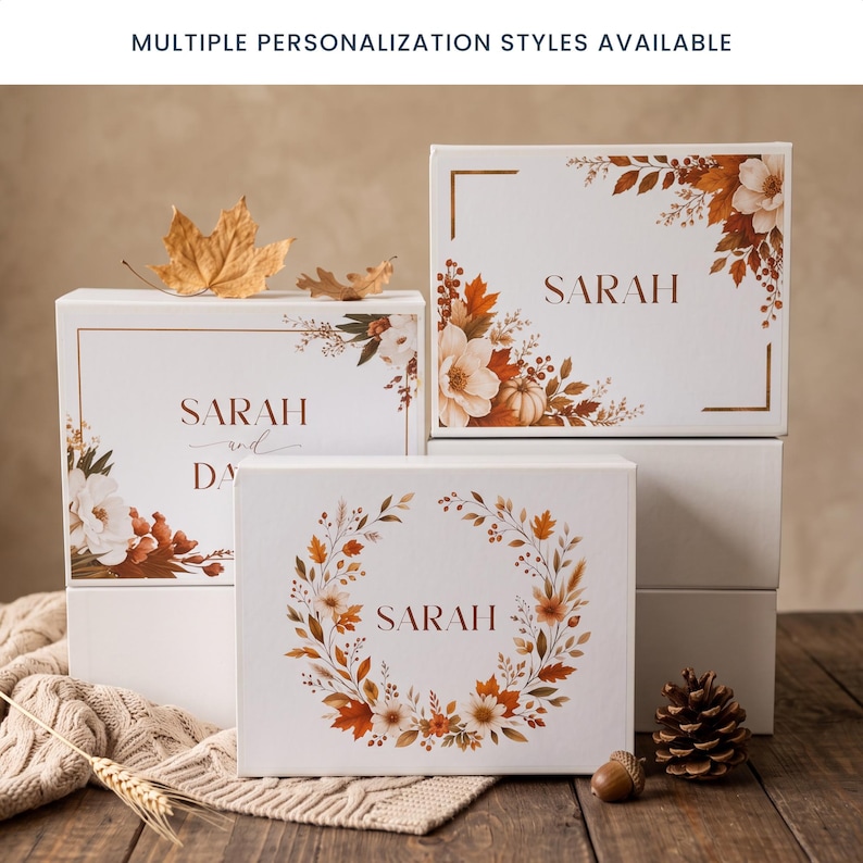 May include: Three white rectangular gift boxes featuring autumn-themed floral and leaf illustrations in shades of orange, brown, and cream. The boxes are personalized with the name SARAH or SARAH AND DAVID. Text at the top reads: MULTIPLE PERSONALIZATION STYLES AVAILABLE.
