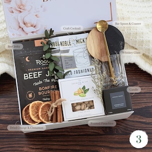 May include: A handmade wooden sign with the text "Welcome" in a whimsical font. The sign is painted white with a distressed finish, and features a decorative floral design in shades of pink and green. It measures approximately 12 inches wide.