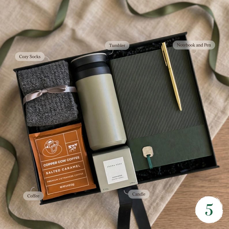 Sage green mens gift basket with cozy socks, insulated tumbler, salted caramel coffee, sandalwood candle and notebook with gold pen — gift box for him