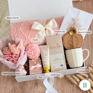 Cute gift box for women with pink dried flower bouquet, candle, 
chocolate bar, and ceramic mug — gift for friend or sister