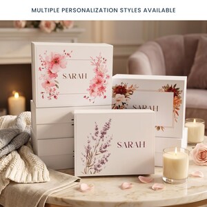 May include: White gift boxes with floral designs and the name "SARAH" printed on them. The boxes feature various floral arrangements in shades of pink, red, and purple. The text "MULTIPLE PERSONALIZATION STYLES AVAILABLE" is at the top.