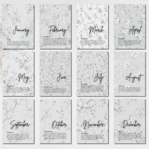 May include: A set of twelve rectangular cards featuring a light gray floral pattern. Each card displays a month name in black script, a corresponding theme word, and a paragraph of text. The text includes the brand name elevatelifebycarla.