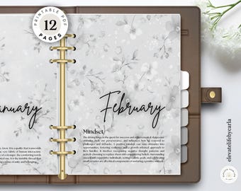 May include: A brown ring-bound planner open to pages labeled January and February, featuring a light gray floral background pattern. The pages include text about mindset and mercy, with a circular badge at the top left stating 12 pages.