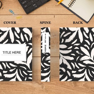 Peut inclure: Une couverture de carnet noir et blanc avec un motif de coups de pinceau et le texte "TITLE HERE" sur le devant. La colonne vertébrale et la couverture arrière présentent le même motif.