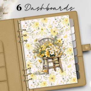 May include: A tan planner is open to a page with a floral design featuring a wooden chair overflowing with yellow and white flowers. The planner has six labeled tabs. The words "6 Dashboards" are at the top.
