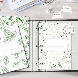 May include: A white binder with three dividers labeled "Home", "School", and "Office". The dividers have a green leafy pattern. The binder has a white background with a green leafy pattern.