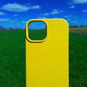 Op de afbeelding: Een felgele telefoonhoes met een uitsparing voor de camera. De hoes is gemaakt van een getextureerd materiaal en heeft een licht verweerde uitstraling.