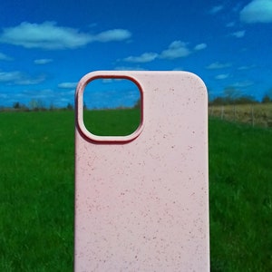 Op de afbeelding: Een roze telefoonhoesje met een gespikkelde textuur. Het hoesje heeft een uitsparing voor de camera.