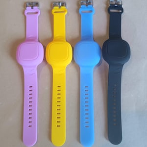 Può includere: Quattro braccialetti in silicone con dispenser di disinfettante per le mani integrati. I braccialetti sono rosa, giallo, blu e nero.