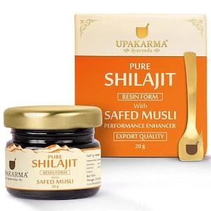May include: A jar of Pure Shilajit Resin Form with Safed Musli, 20g, alongside a box with the same text and a golden spoon. The jar has a gold lid and a label with the brand name Pakarma Ayurveda.
