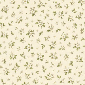 May include: A repeating pattern featuring small white apple blossoms with yellow centers and green leaves scattered across a light cream-colored background. The botanical illustration style shows clusters of flowers and individual buds.
