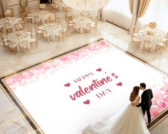 May include: A white dance floor with a pink and white heart design. The floor has the text "Happy Valentine's Day" in red. A bride and groom are standing on the dance floor.