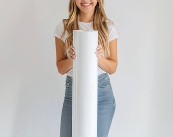 May include: A woman holds a large white roll of paper in front of her. The roll is about 30 inches long and 12 inches wide.