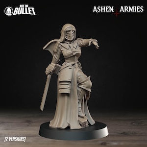 May include: A detailed, beige-colored miniature figure of a warrior in armor, holding a sword. The figure is on a black base, with the text "Bite the Bullet" and "Ashen Armies" visible. The figure is in a dynamic pose.