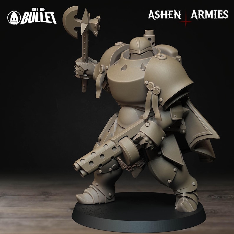 May include: A detailed, tan-colored miniature figure of a heavily armored warrior, holding a large axe and a multi-barreled weapon. The figure is on a black base, with the text "Bite the Bullet" and "Ashen Armies" visible.