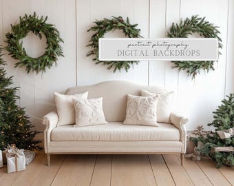 May include: A cream-colored sofa with decorative pillows sits in front of a white wall adorned with evergreen wreaths. The scene includes a Christmas tree, gifts, and the text "portrait photography DIGITAL BACKDROPS."