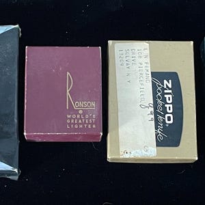 May include: Collection of vintage lighters and a Zippo pocket knife in their original boxes. Includes a Scripto butane lighter with instructions, a Ronson lighter box, and a blue Scripto lighter.