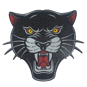 May include: A black panther head with a red mouth and yellow eyes. The panther is snarling with its teeth bared.