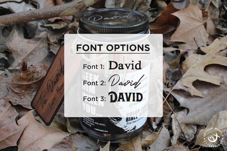 May include: A clear glass jar with a black lid, showing font options for the name "David". The jar is set amongst fallen leaves. A wooden tag with the inscription "To: David, Love: Mom" is also visible.
